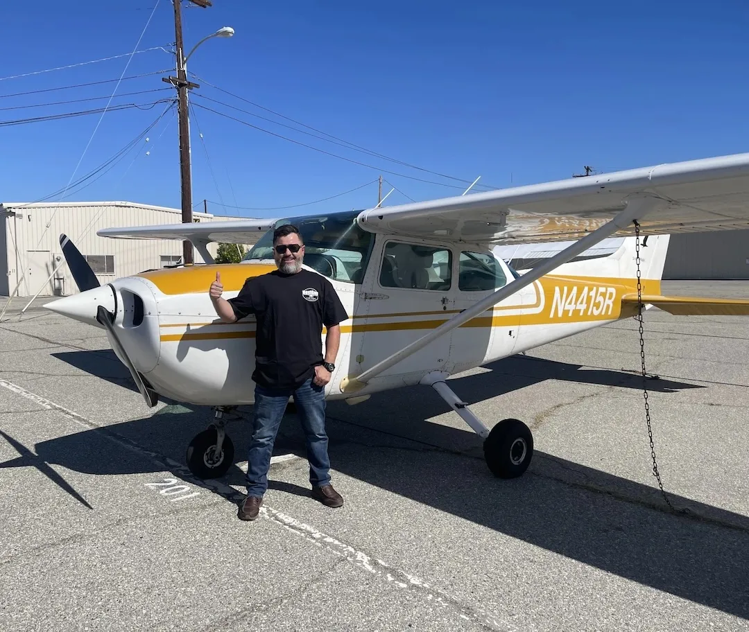 Smiling pilot completing a checkride at NextGen Flight Academy.